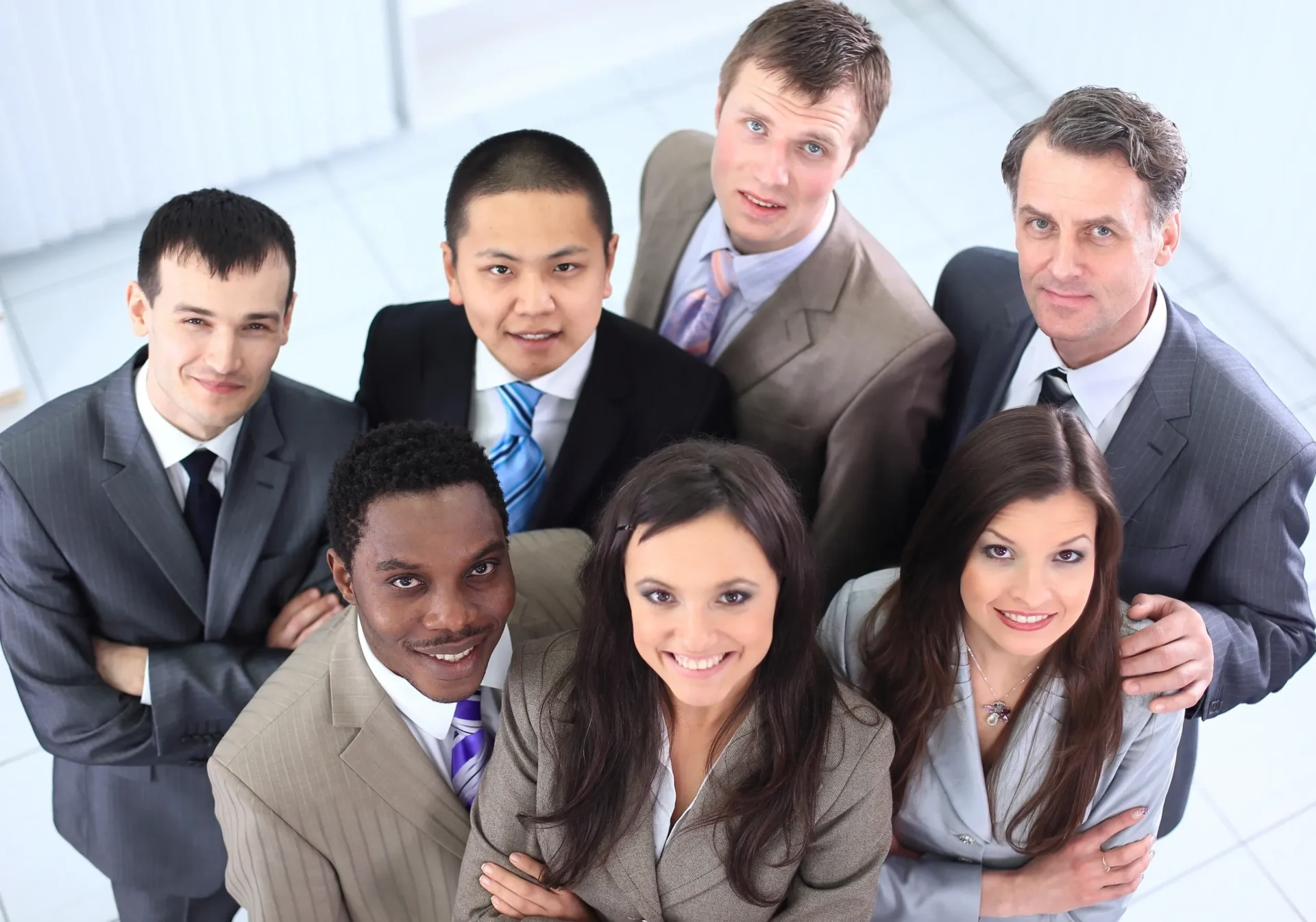 A group of people in suits and ties posing for the camera.